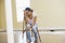 Woman sitting on ladder in empty space looks tired