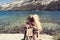 Woman sitting at a lake in Yosemite Park. wanderlust concept