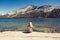 Woman sitting at a lake in Yosemite Park. wanderlust concept