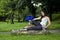 Woman sitting on log with open fan