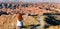 Woman sitting and looking mountain desert and road curve- thinking,  travel,  opportunity concept  Gorafe desert