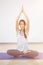 Woman sitting in lotus pose with eyes closed