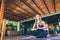 Woman sitting in a lotus position in a tropical gym