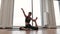 Woman sitting in Mermaid Pose during session in yoga studio