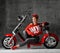 Woman sitting on motorcycle bicycle scooter retro pinup style in red blouse and jeans