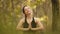 Woman sitting namaste yoga pose in spiritual relaxation serenity and meditation in the forest