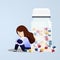 Woman sitting near pill bottles