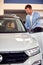 Woman sitting in a new car in sales auto salon