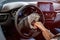 Woman sitting in new car and showing dollars and keys