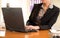 Woman sitting in the office in front of the laptop