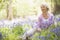 Woman sitting outdoors with flowers smiling