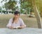 Woman sitting at a park table reading a book. World book day.