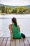 Woman sitting on a pier in front of lake Orfu , in Hungary