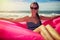 A woman sitting on a pink air boat on the beach