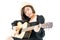 Woman sitting and playing guitar guitar folk song in her hand