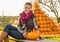 Woman sitting with pumpkin