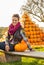 Woman sitting with pumpkin