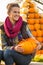 Woman sitting with pumpkin