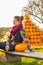 Woman sitting with pumpkin