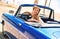 Woman sitting in retro cabriolet car