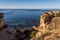 A woman is sitting on the rock on the Atlantic