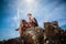 woman sitting on a rock slow travel