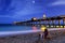 Woman sitting on shore at night