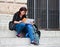 Woman sitting on the stairs and sees the map