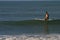 Woman Sitting on Surfboard