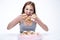 Woman sitting at the table with cake at her face