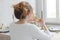 Woman sitting at table eating sandwich