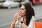 Woman sitting at a table on the street. Evening warm city.