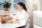 Woman sitting with tablet PC on the background of humidifier