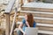 Woman sitting thinking with her laptop