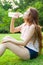 Woman sitting tired and drinking water after exercise.