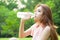 Woman sitting tired and drinking water after exercise.