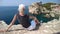 Woman sitting on top of Dubrovnik city of Croatia