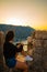 Woman sitting on top of hill on sunset with beautiful view of kotor