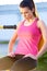 Woman sitting on weights machine breathing.