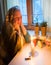 Woman sitting by the window with candles