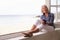 Woman Sitting At Window And Looking At Beautiful Beach View