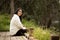 Woman Sitting in Wood Platform in Forest Preserve Contemplating the Scenery