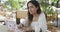 Woman sitting working at an outdoor cafeteria