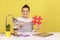 Woman sitting at workplace, pointing at big hashtag symbol to laptop screen, sharing viral content.