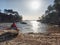 Woman sitting in wrecked boat and enjoy sunbathing.