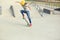 Woman skateboarder jumping at skatepark