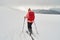 Woman ski touring on an overcast day with poor visibility, in Baiului mountains, Romania - view from behind