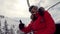 Woman Skier Climbs On The Chair Lift To The Top Of The Mountain Shows Thumb Up