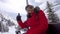 Woman Skier Climbs On The Chair Lift To The Top Of The Mountain And Waving Hand