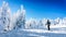 Woman skier enjoying the winter landscape of snow and ice covered trees